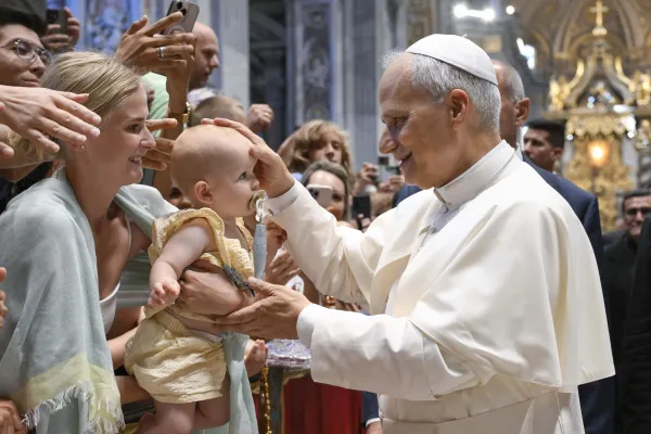 Pope Leo XIV blesses a baby during his Wednesday general audience in St. Peter’s Basilica on Aug. 13, 2025, at the Vatican. / Credit: Vatican Media