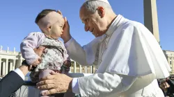 Pope Leo XIV blesses a baby in St. Peter’s Square during his general audience on Wednesday, Nov. 5, 2025, at the Vatican. / Credit: Vatican Media