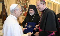 Archbishop Gintaras Grušas and Greek Orthodox Archbishop Nikitas Loulias present the signed updated Ecumenical Charter to Pope Leo XIV on Nov. 6, 2025. / Credit: Vatican Media