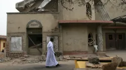 A Catholic Priest walks in front of St. Leo the Great Catholic Church in Enugu State, Nigeria. Credit: ACN