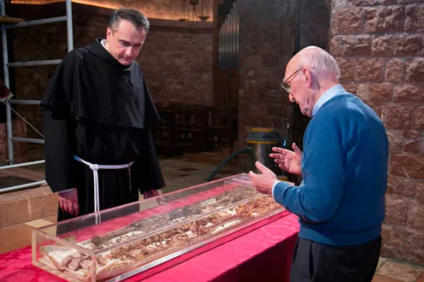 From the opening of St. Francis of Assisi’s tomb in 2015, showing the then-custos of the Sacred Convent, Father Mauro Gambetti, inspecting the remains of the saint’s body. | Credit: Photo courtesy of the Sacred Convent of Assisi