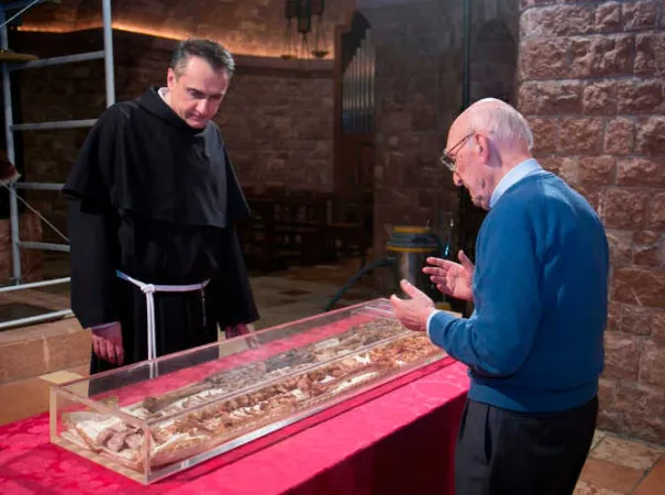 From the opening of St. Francis of Assisi’s tomb in 2015, showing the then-custos of the Sacred Convent, Father Mauro Gambetti, inspecting the remains of the saint’s body. | Credit: Photo courtesy of the Sacred Convent of Assisi