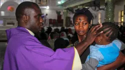 A priest signs the forehead of a child as catholics take part in the Ash Wednesday celebration at the St. Patrick cathedral in Maiduguri on February 26, 2020. Credit: AFP/Getty