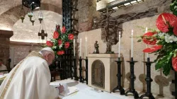 Pope Francis signs his new encyclical, Fratelli tutti, on the altar before the tomb of St. Francis of Assisi on Oct. 3, 2020. / Vatican Media.