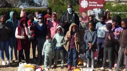 Officials of Caritas Aliwal in South Africa led by Bishop Joseph Kizito pose for a photo with some immigrant children in the Catholic Diocese/Credit: Bishop Joseph Kizito/ Caritas Aliwal North / Bishop Joseph Kizito/ Caritas Aliwal North