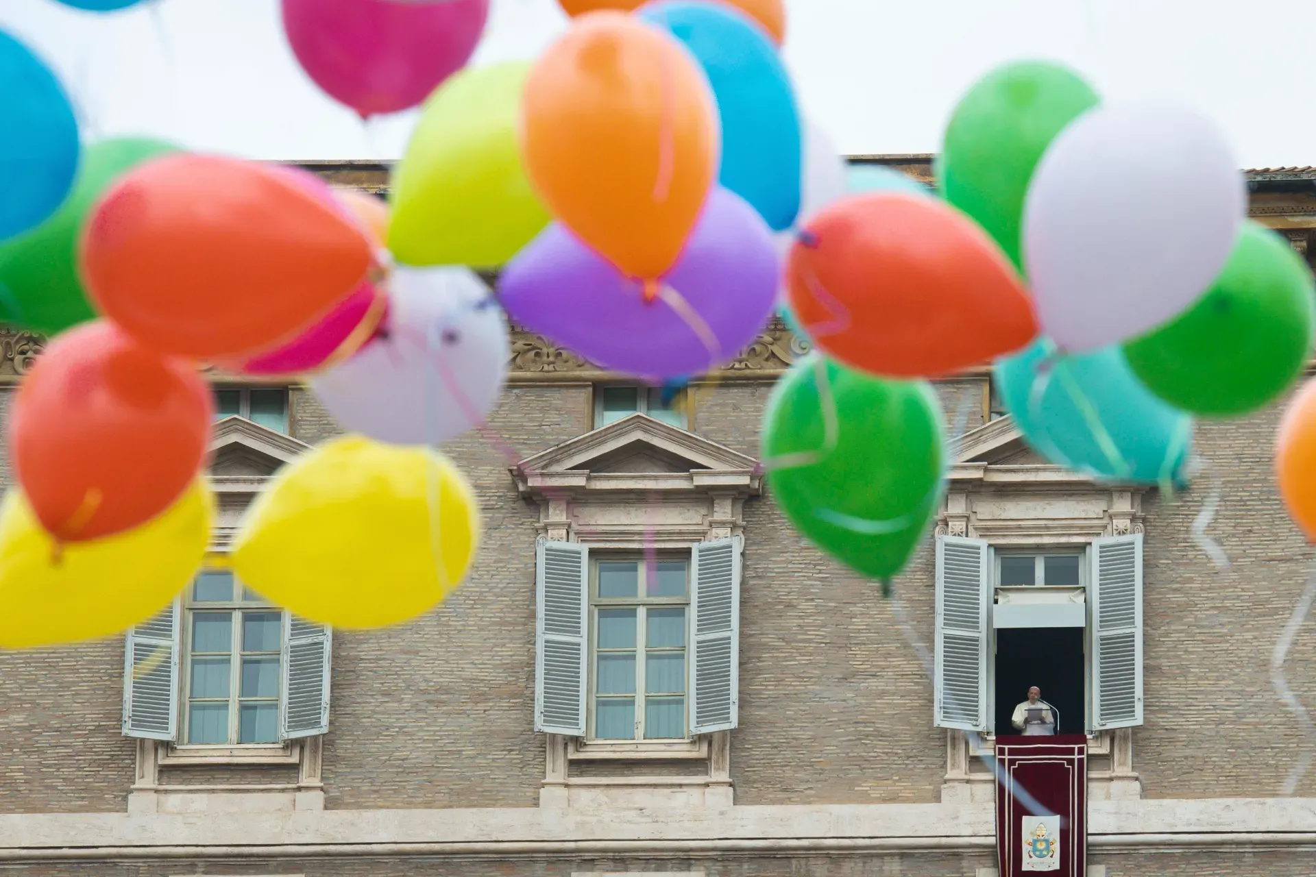 Children participating in a Catholic Action initiative helped to release colorful balloons at the end of the Angelus on Jan. 30, 2022. Vatican Media