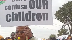 A protester carrying a placard during the July 13 peaceful demonstration. Credit: Episcopal Conference of Malawi (ECM)