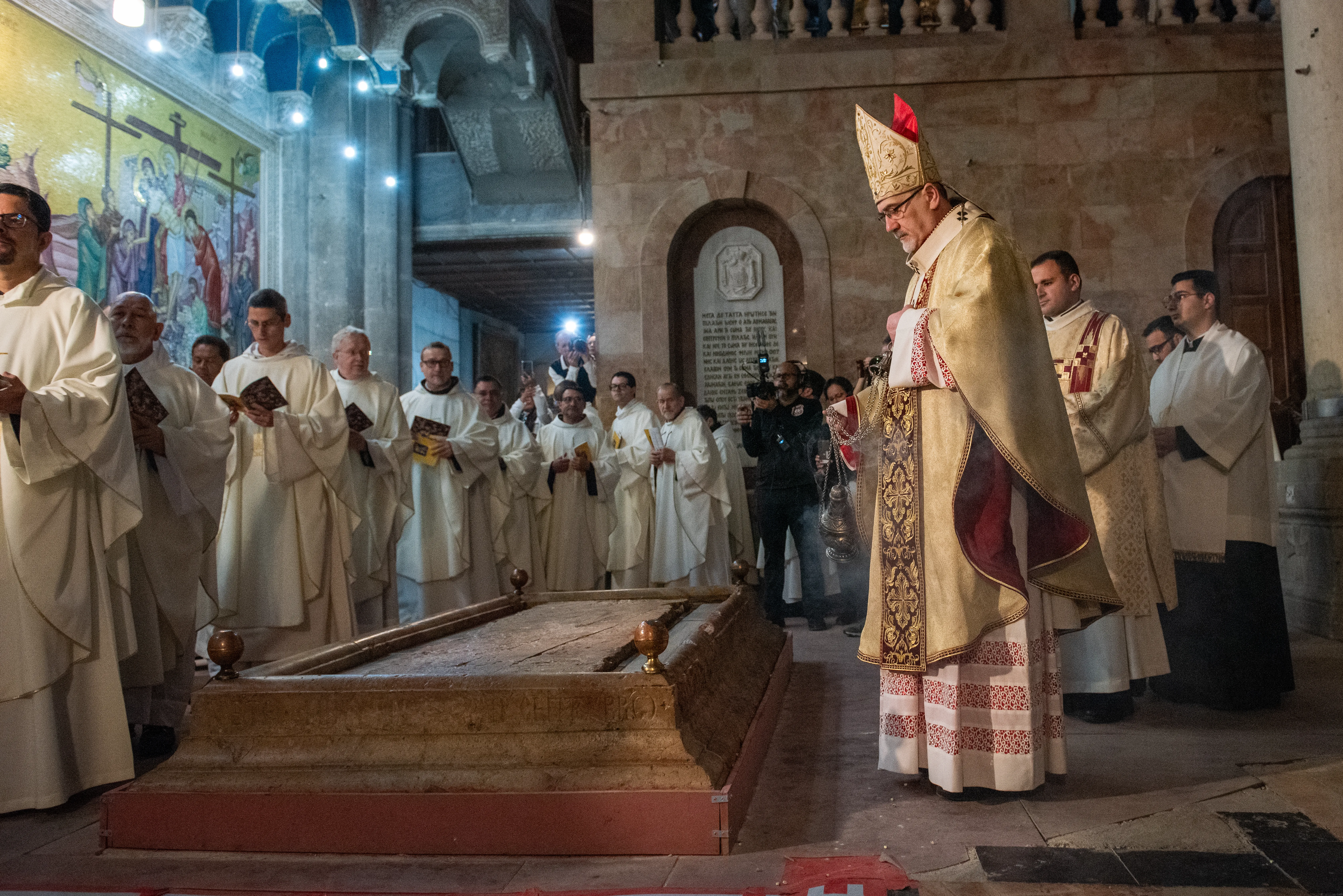 With the incense burned from the newly blessed fire, Cardinal Pierbattista Pizzaballa, the Latin patriarch of Jerusalem, incenses the "Stone of Anointing," located at the entrance of the Basilica of the Holy Sepulcher, where, according to tradition, the body of Jesus was anointed and prepared with aromatic oils for burial. March 30, 2024. / Credit: Marinella Bandini