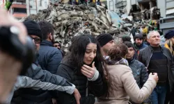 A woman reacts as rescuers search for survivors through the rubble of collapsed buildings in Adana, Turkey, on Feb. 6, 2023, after a 7.8-magnitude earthquake struck the country’s southeast. The combined death toll for Turkey and Syria after the region’s strongest quake in nearly a century is in the thousands. / Photo by CAN EROK/AFP via Getty Images