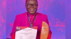 Bishop Matthew Hassan Kukah of Nigeria's Sokoto Diocese is awarded a certificate following his participation at the G20 Religion Forum in Bali, Indonesia. Credit: Kukah Foundation