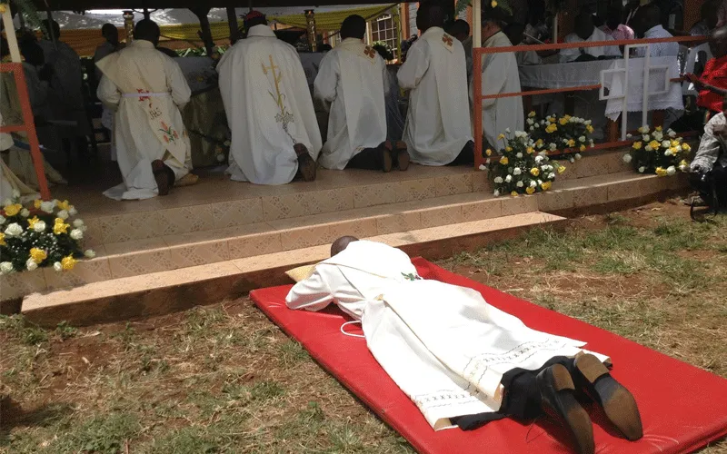 A seminarian lays prostrate during his diaconate ordination / Bishop James Maria Wainaina/ Facebook