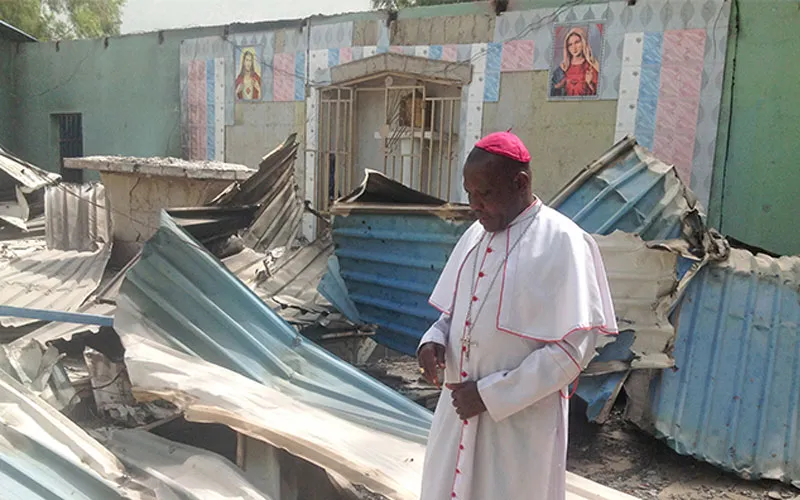 Bishop Oliver Doeme inspecting a burnt church in Bahuli, Maiduguri. Credit: ACN