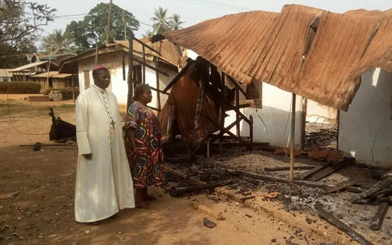 Archbishop Andrew Nkea Fuanya of Bamenda Archdiocese, sympathizing with a woman whose house was burnt down in the ongoing Anglophone crisis.