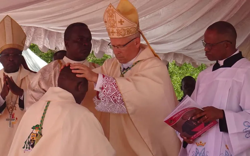 Archbishop Hubertus van Megen lays hands on the head of Bishop George Muthaka, during his episcopal ordination May 7 at Our Lady of Consolation Cathedral of Garissa Diocese grounds. Credit: Garissa Diocese