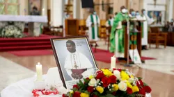Foreground: Image of Servant of God, Maurice Michael Cardinal Otunga during Holy Mass at Holy Family Basilica, Nairobi on 6 September 2021, to mark 18 years since the Kenyan Cardinal died. Credit: Archdiocese of Nairobi/Facebook