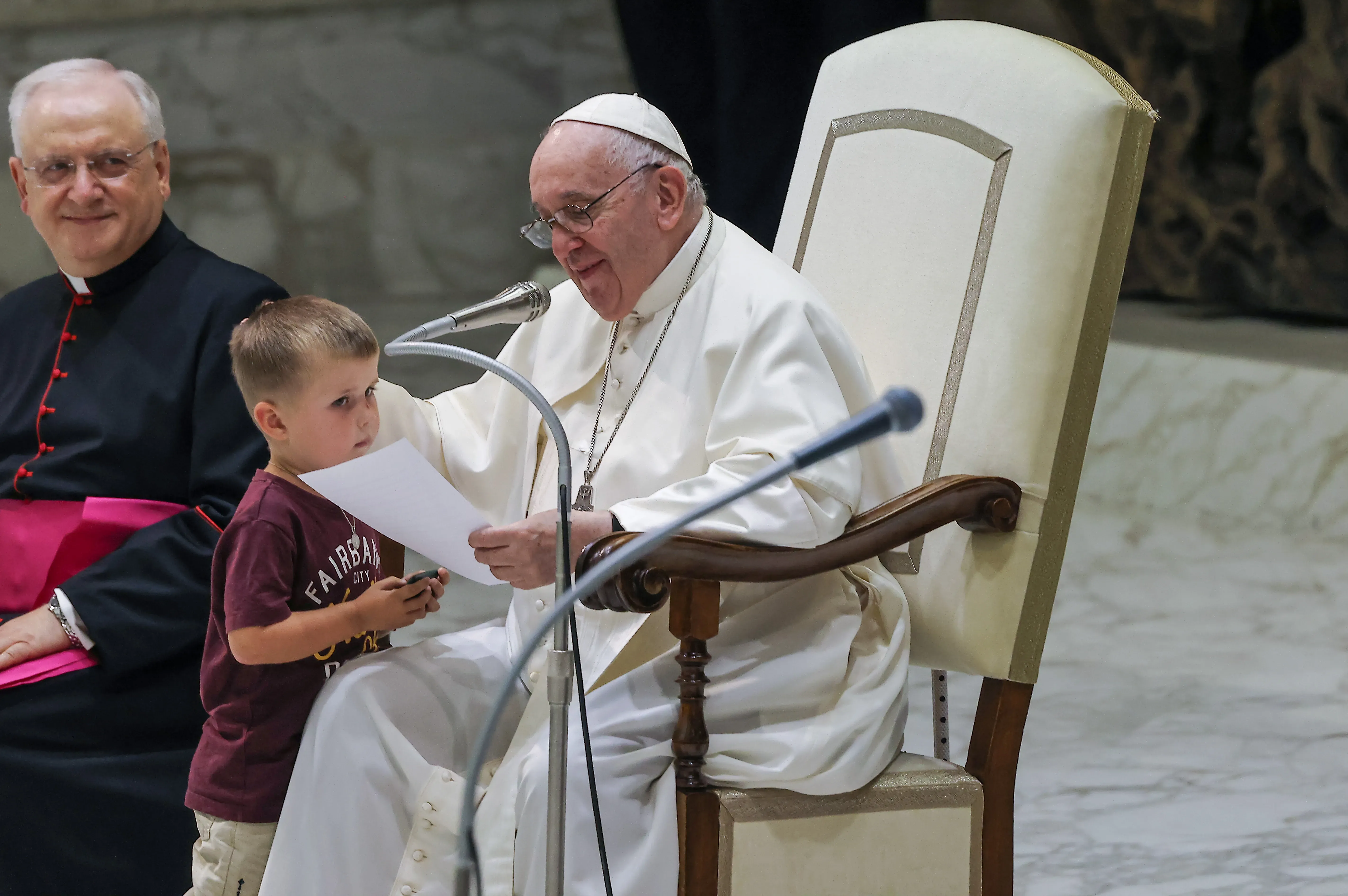 Pope Francis with a surprise visitor on stage at the General Audience in the Vatican on Aug. 17, 2022. Pablo Esparza / CNA