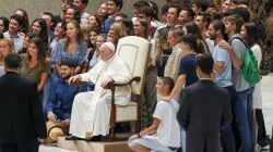 Pope Francis poses for a photo with a group of young people after his general audience Aug. 17, 2022. | Pablo Esparza/CNA