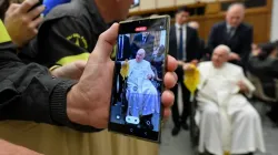 A person takes a photo of Pope Francis on a cell phone during a papal audience on Dec. 10, 2022. | Vatican Media