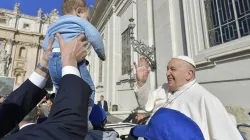 Pope Francis blesses a baby at his Wednesday general audience on March 20, 2024, in St. Peter’s Square at the Vatican. / Credit: Vatican Media