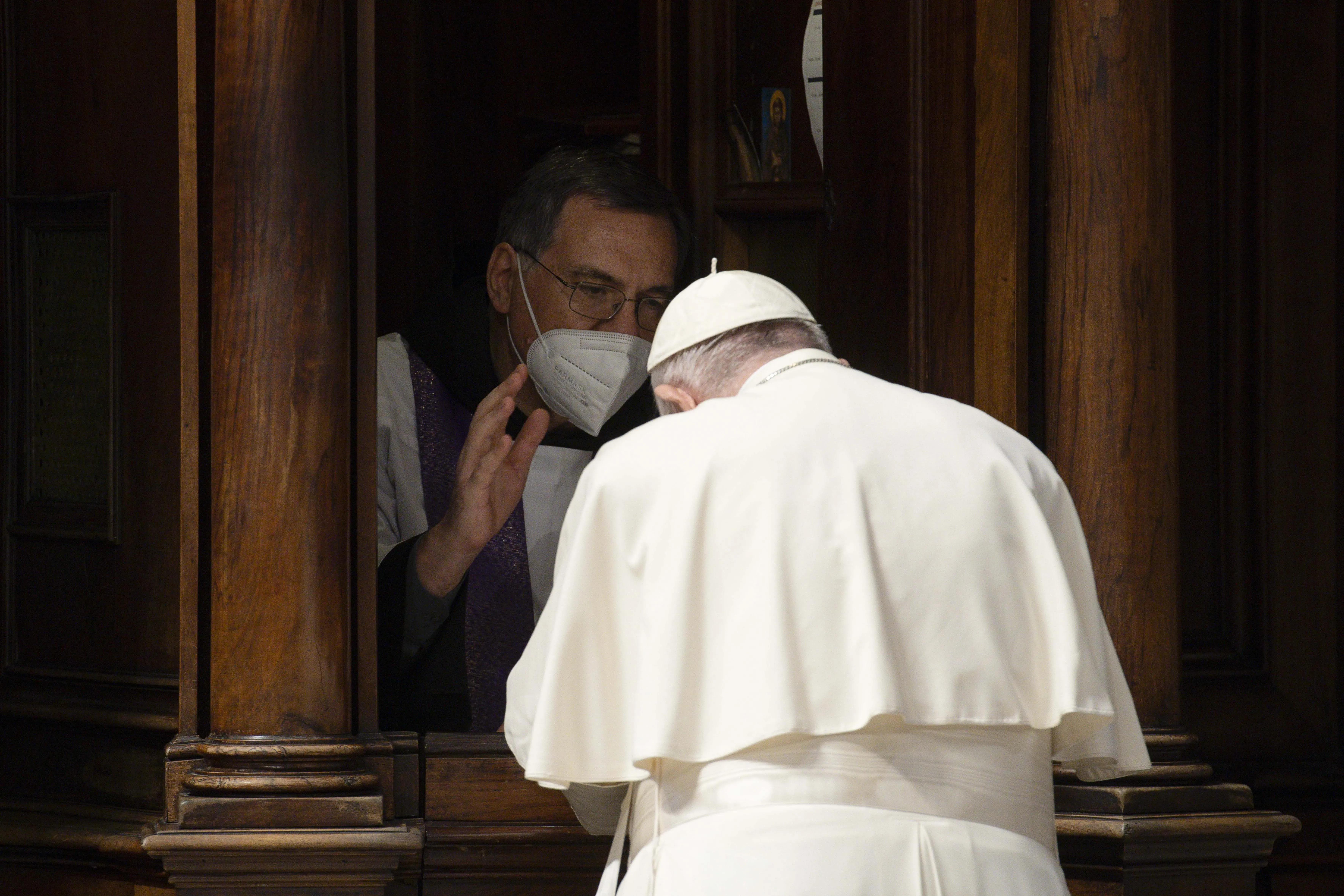 Pope Francis goes to confession during a penance service in St. Peter's Basilica on March 25, 2022. Vatican Media.