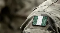 The flag of Nigeria on a military uniform. Bumble Dee/Shutterstock.