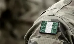 The flag of Nigeria on a military uniform. Bumble Dee/Shutterstock.