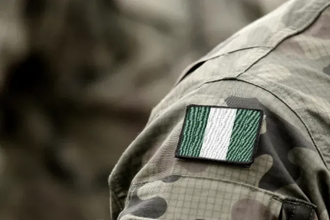 The flag of Nigeria on a military uniform. | Bumble Dee/Shutterstock.
