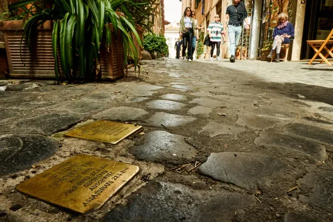 "Stumbling blocks" in Rome, Italy. Plates inscribed with the name and dates of life of the victim of Nazi persecution. | Shutterstock