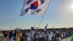 Pilgrims from South Korea wave a flag at Mass with Pope Francis for the closing of World Youth Day 2023 in Lisbon on Aug. 6, 2023. | Hannah Brockhaus/CNA