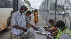 Commuters get COVID-19 test results checked at the South African side of the border -- but a surge in cases is overwhelming authorities on both sides.