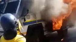 A man wearing a helmet approaches a burning van in Johannesburg
Credit: Denis Hurley Peace Institute