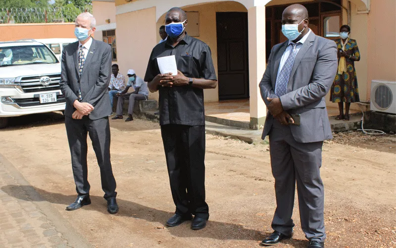 Fr. James Oyet Latansio (Center), UK ambassador Christopher Trott (left) and Christian Aid Country Director (right) after the launch  a helpline center for psychosocial and trauma healing of the people affected by COVID-19 in South Sudan. / ACI Africa