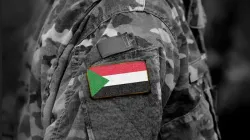 Flag of Sudan on soldier's arm. Credit: Bumble Dee/Shutterstock