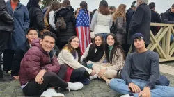 Juan Luis Tron (second from left) and Maria Magdalene Baca (second from right) together with other young people from the Regnum Christi movement wait outside St. Peter's Basilica on Jan. 2, 2023, to pay their respects to the late Pope Benedict XVI, who died Dec. 31, 2022. Hannah Brockhaus / CNA