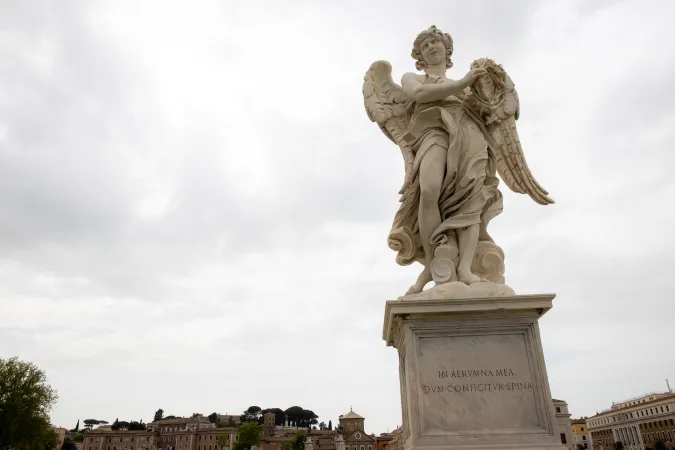 The angel holding the crown of thorns, one of Bernini's own sculptures, stands against Rome's skyline with the inscription 'In aerumna mea dum configitur spina' (In my affliction, while the thorn is driven in).