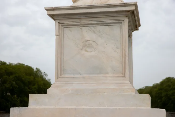 A visible cannonball dent marks the pedestal of an angel statue on Ponte Sant'Angelo, a battle scar from the defense of the Vatican in 1870.