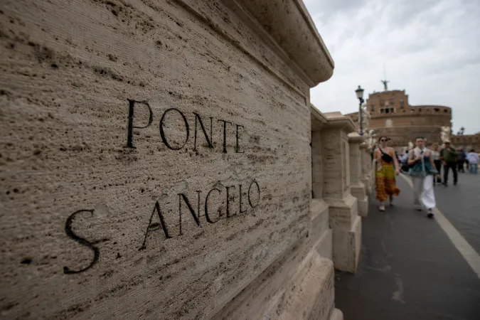 The name 'Ponte S. Angelo' etched in the bridge's travertine stone, a testament to its centuries-old identity in the heart of Rome