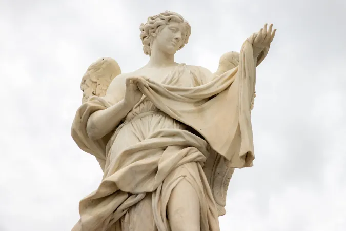 An angel holding the cloth likely representing the Veil of Veronica.