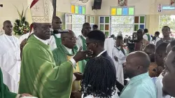 Archbishop Samule Kleda became Douala’s Catholic leader in 2009. Under his leadership, the Catholic population has doubled. Of the 88 parishes under his governance, he built 46. On September 28, he visited the parish of St. Marc de la Cité des Palmiers, where he administered Holy Communion and Confirmation to 90 youth and adults. Here, he gently taps a confirmee on the cheek, as a sign that as a soldier of God, he must now be a willing martyr. Kleda’s predecessor, Cardinal Christian Tumi (1991-2009) was Cameroon’s only cardinal to date. He is buried in Douala’s cathedral. Credit: Victor Gaetan / National Catholic Register