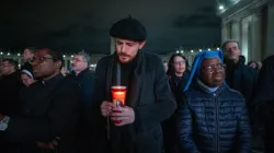 Clergy, religious, and lay faithful gather in St. Peter’s Square for the nightly rosary vigil, holding candles and rosaries as they pray for Pope Francis’ recovery, Feb. 28, 2025. | Credit: Daniel Ibáñez/CNA