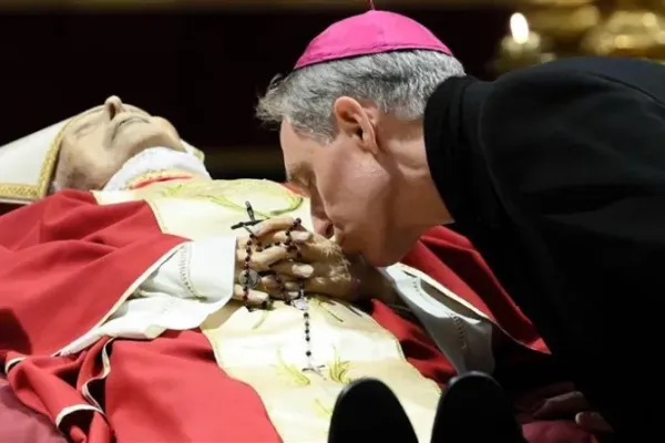 Archbishop Georg Gänswein bent down to kiss the hands of his friend and mentor, Pope Emeritus Benedict XVI. | Vatican Media