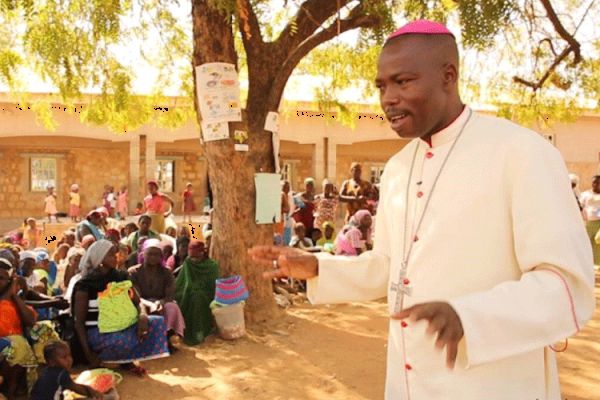 Bishop Stephen Dami Mamza comforting IDPs in Adamawa State.
