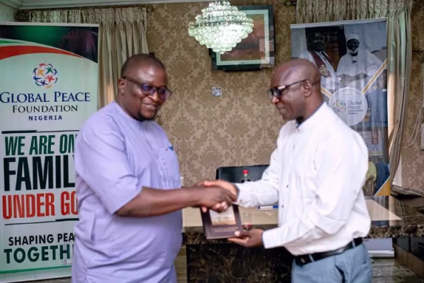 The CD GPF Nigeria Rev.John Joseph Hayab presenting a Book Titled "Korean Dream" to the Facilitator Mr.Austin Anyio. Credit: Global Peace Foundation Nigeria