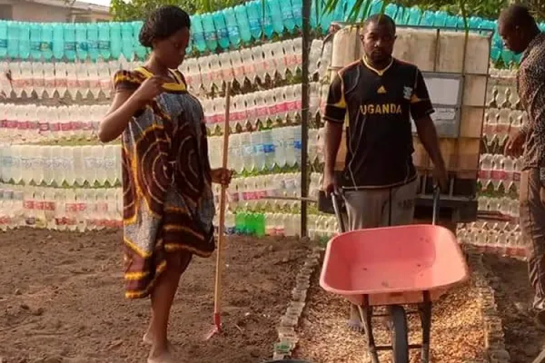 Fr. Innocent Akum Wefon pushing a wheelbarrow in his kitchen garden at St. Raphael Archangel Parish of the Catholic Archdiocese of Douala. Credit: 3650 Plastics At 10