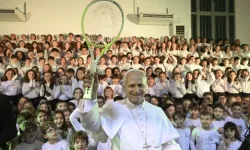 Pope Leo XIV holds up a tennis racket given to him by children of the Pope Paul VI Pontifical School in Castel Gandolfo on Dec. 16, 2025. / Credit: Vatican Media