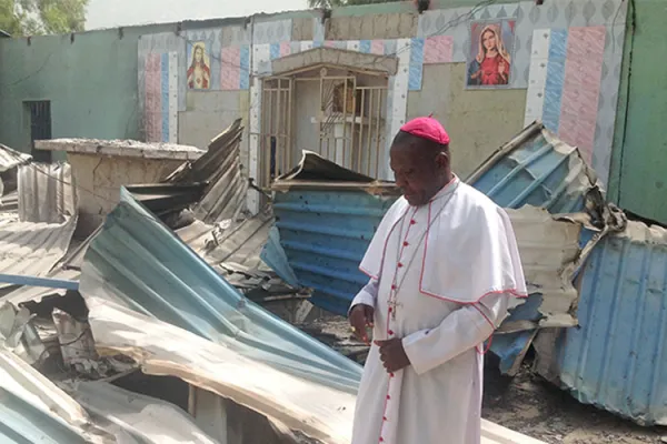 Bishop Oliver Doeme inspecting a burnt church in Bahuli, Maiduguri. Credit: ACN