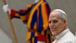 Pope Leo XIV sits during the Jan. 21, 2026, general audience alongside a Swiss Guard at the Vatican. | Credit: Vatican Media