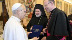 Archbishop Gintaras Grušas and Greek Orthodox Archbishop Nikitas Loulias present the signed updated Ecumenical Charter to Pope Leo XIV on Nov. 6, 2025. / Credit: Vatican Media