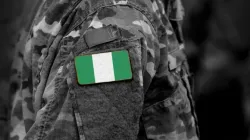 Flag of Nigeria on soldiers arm. | Credit: Bumble Dee/Shutterstock